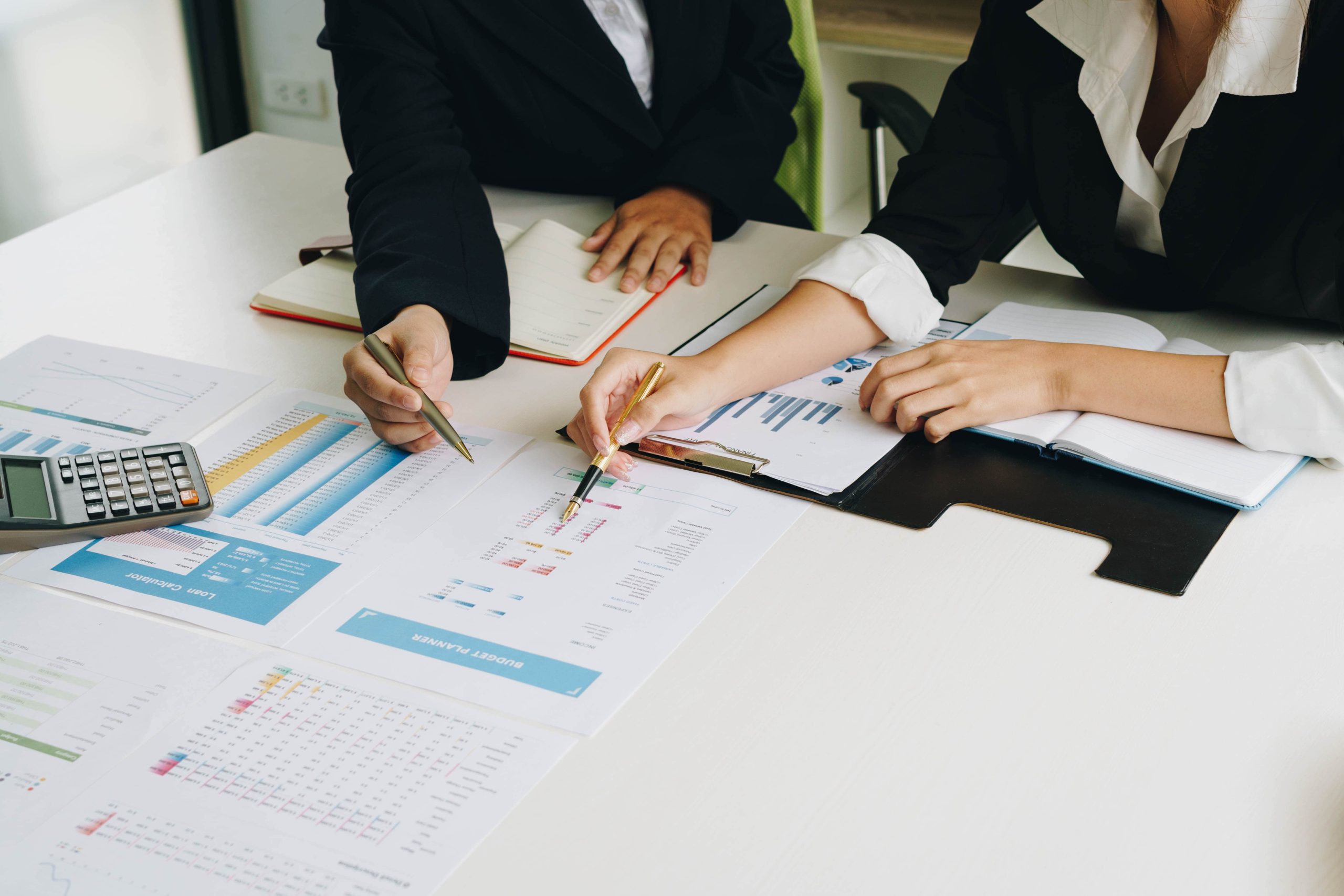 high-angle-view-business-people-discussing-data-desk-office-min